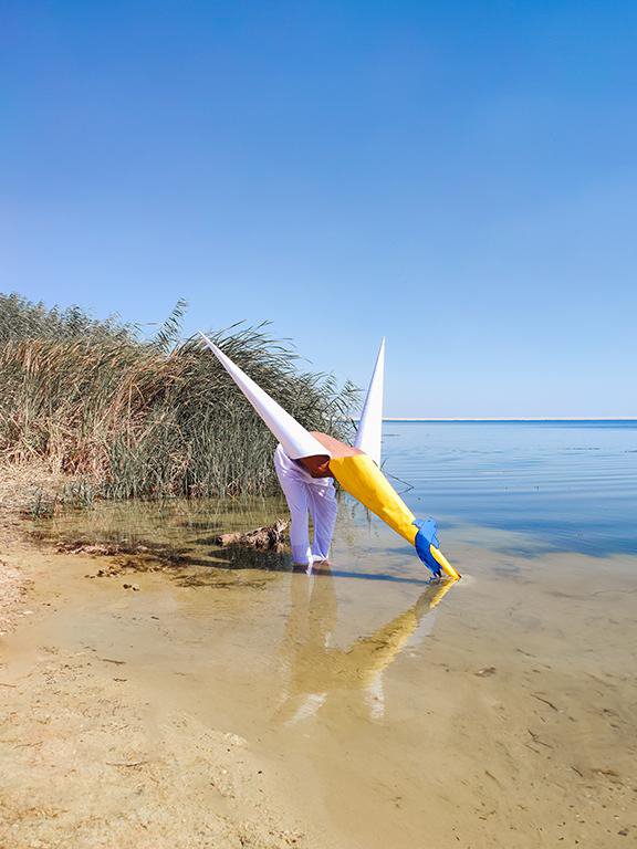 A white hooded figure by the sea — Hashim Nasr